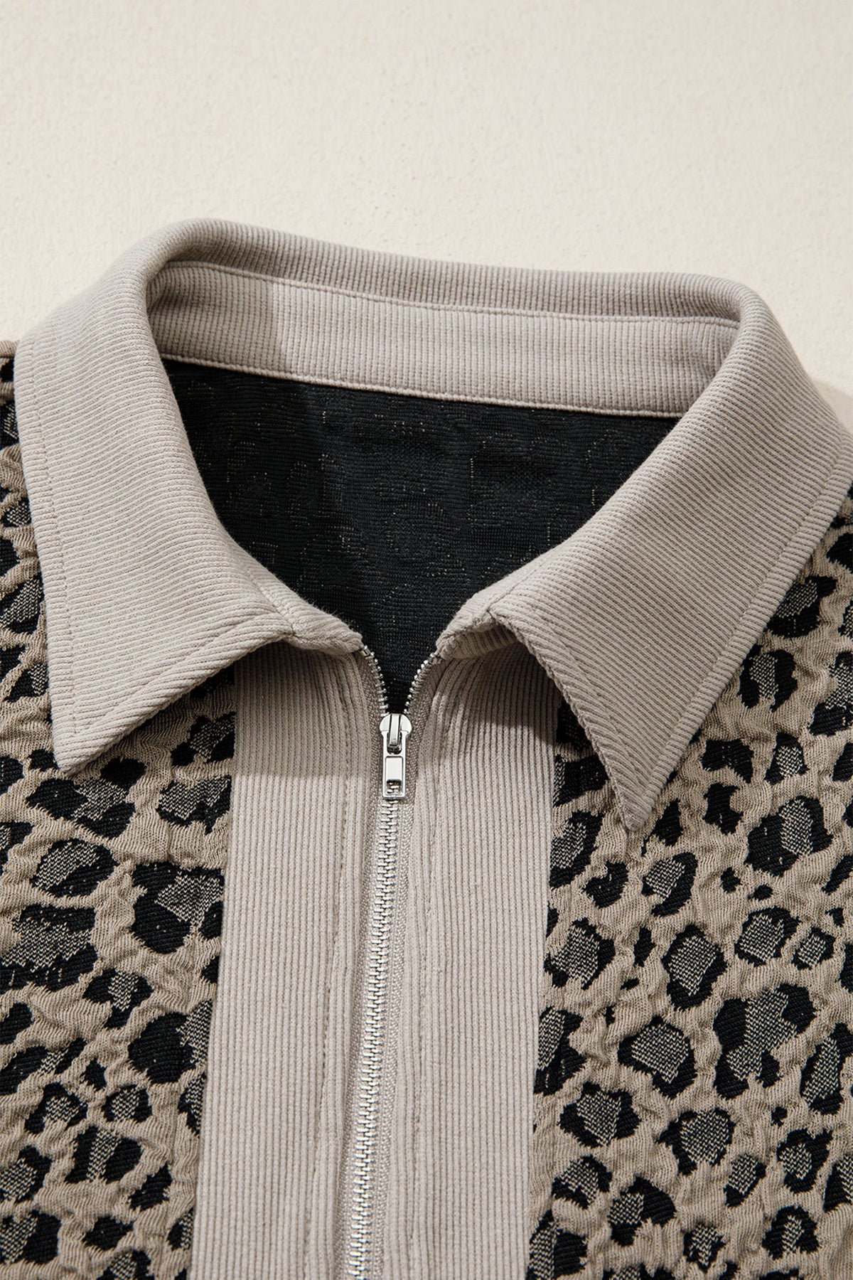 The Lina Leopard Zip-Up Collared Cap Sleeve Top